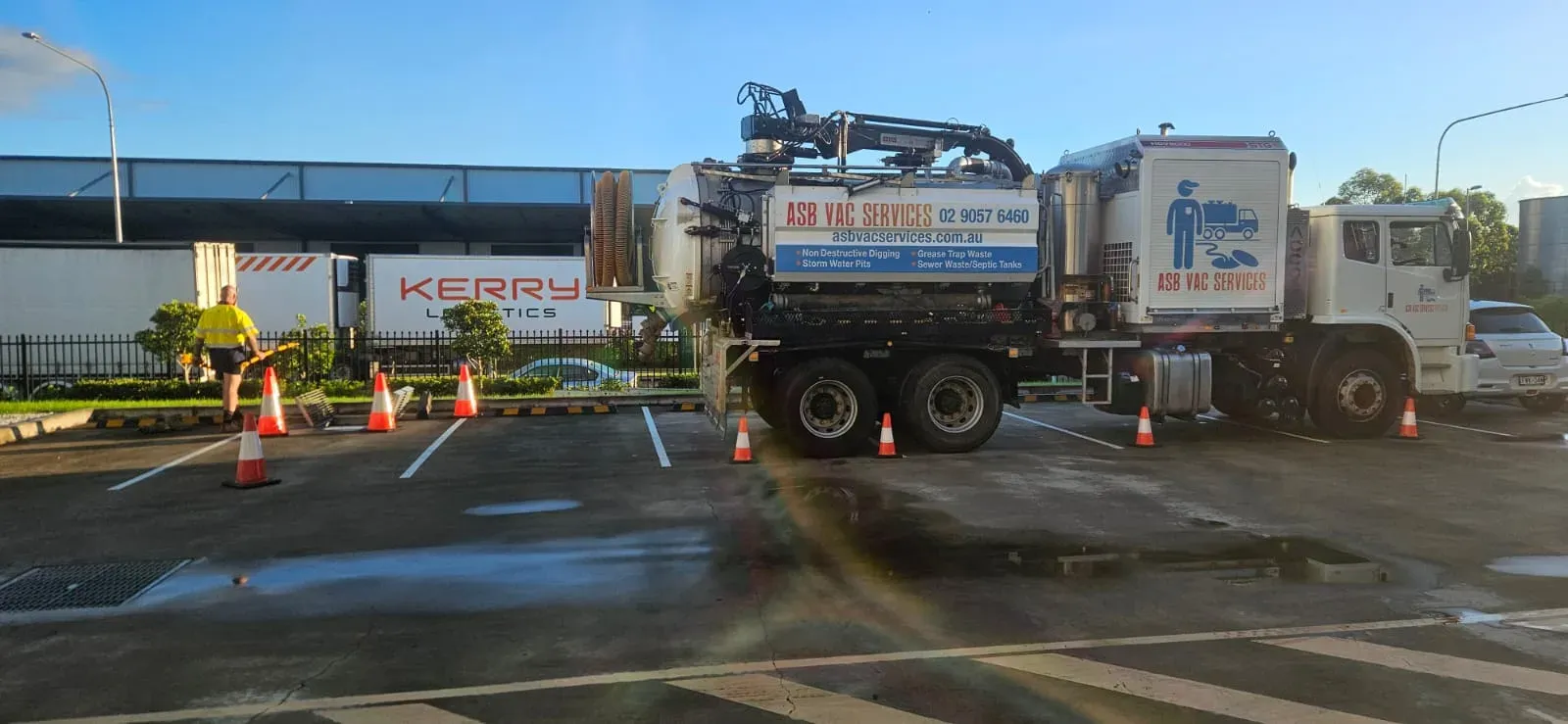 ASB Vac Services truck deployed at a Sydney logistics depot with cones and crew on site