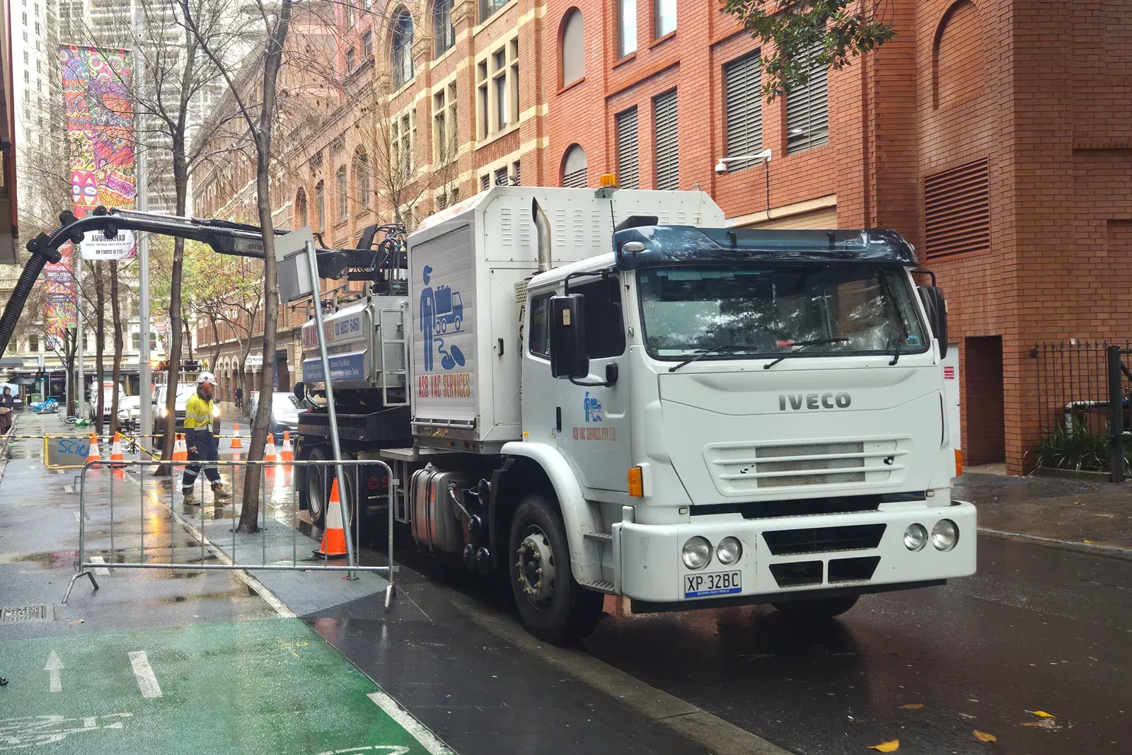 ASB Vac Services truck with boom and suction hose deployed during an emergency pump-out at a commercial building in the Sydney CBD