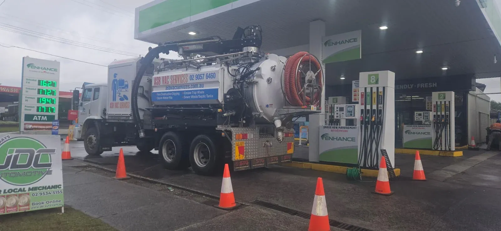 ASB Vac Services truck performing scheduled vacuum service at a Sydney service station forecourt